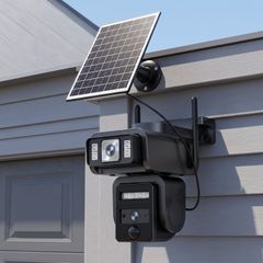 Dual-lens solar security camera and solar panel on house siding in daylight