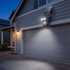 The camera at night, floodlights lighting a driveway in full colour