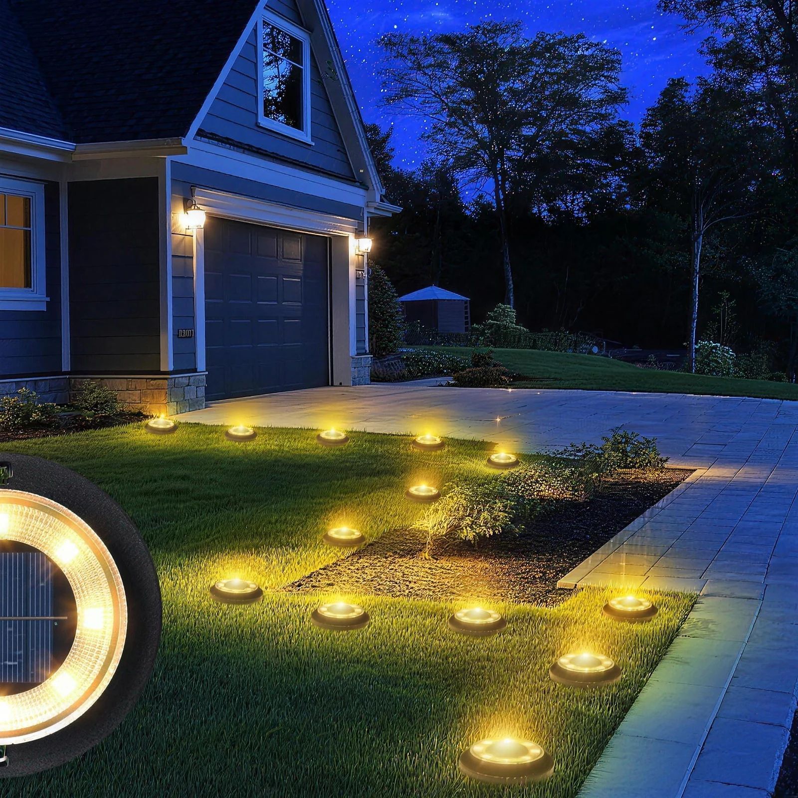 Solar ground lights edging a driveway lawn at night