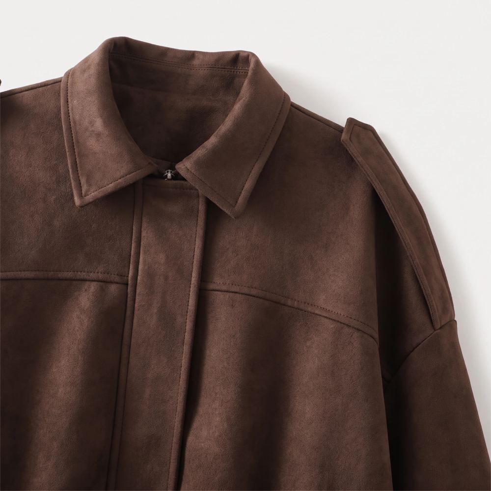 Close view of the collar, zip and shoulder tab on the coffee suede-look jacket